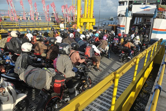 Sejumlah pemudik bersepeda motor antre masuk ke kapal ferry pada H-4 Lebaran di Pelabuhan Gilimanuk, Jembrana, Bali, Senin (13/7).
